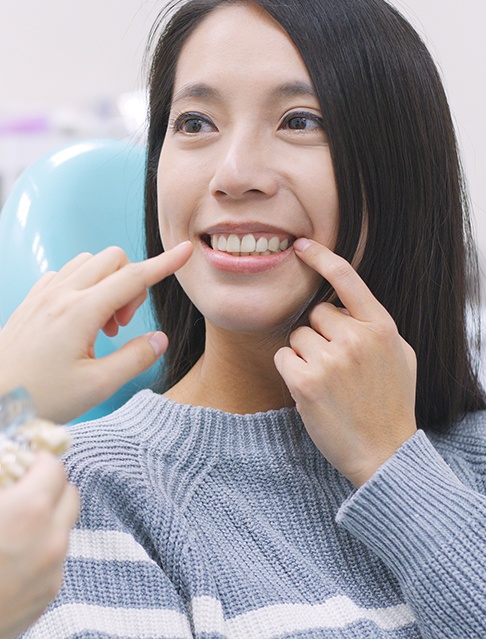 Dentist in Castle Rock reviewing dental bonding candidacy with a smiling patient