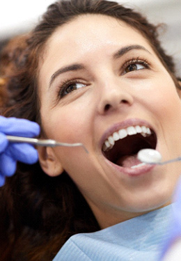 Woman with curly hair about to undergo dental exam