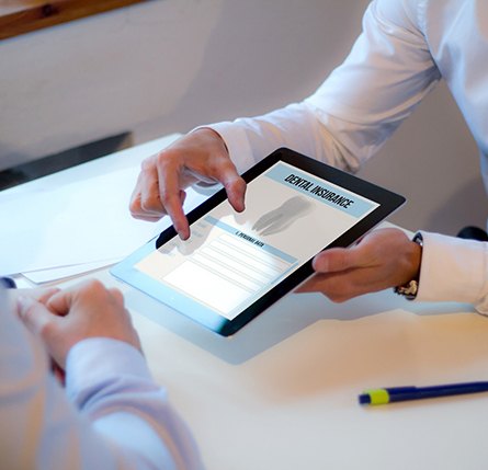 Patient reviewing dental insurance form on tablet