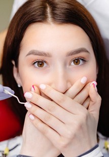 Patient in Parker covering their mouth