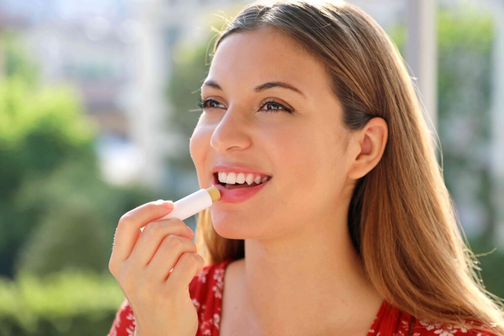 Woman using lip balm