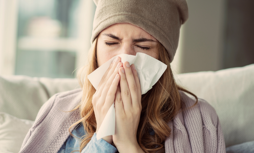 Woman blowing nose