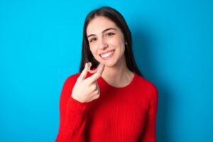 Teen girl holding clear aligner.